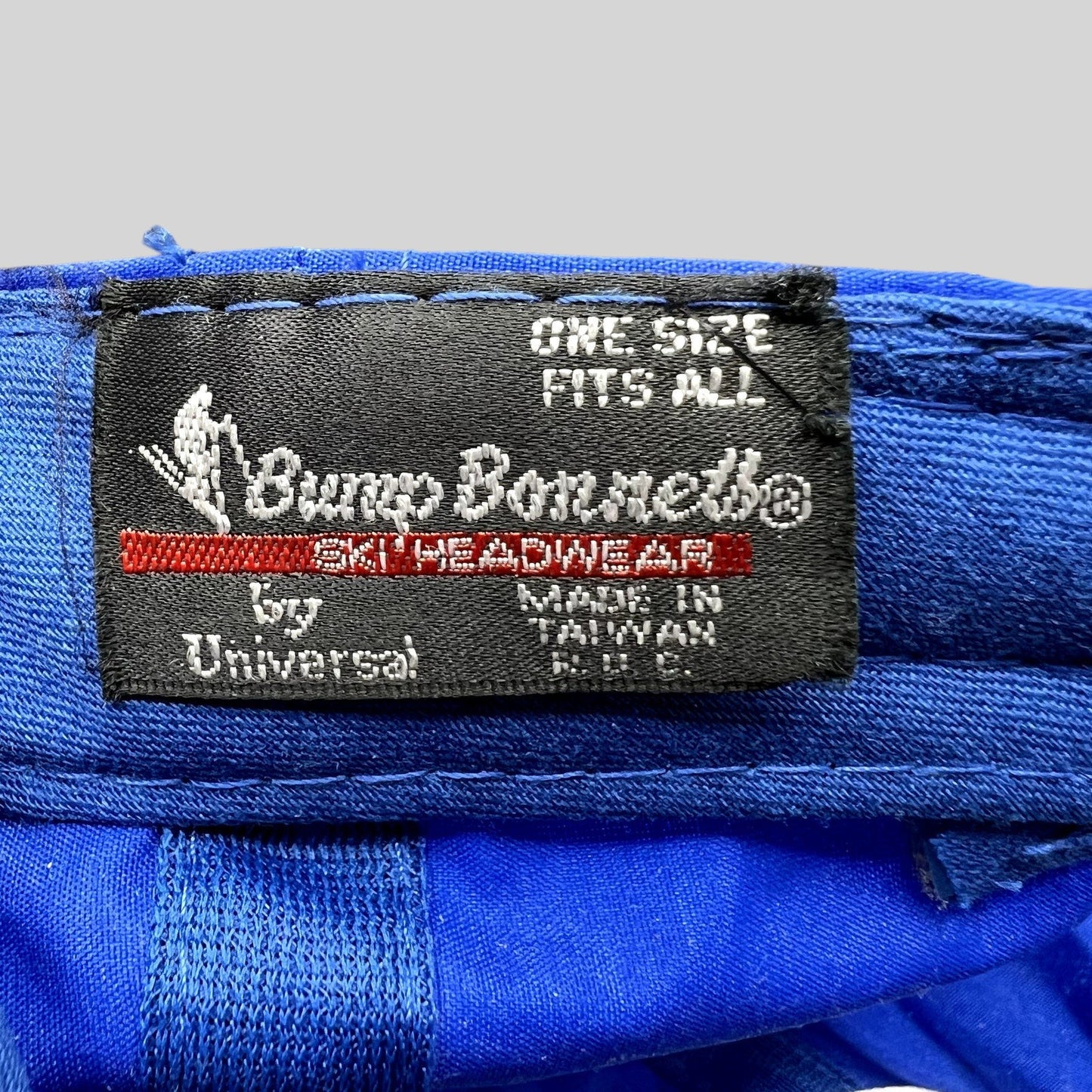 Raree Finds vintage Bump Bonnets hat interior label showing brand logo and manufacturing details on blue nylon fabric