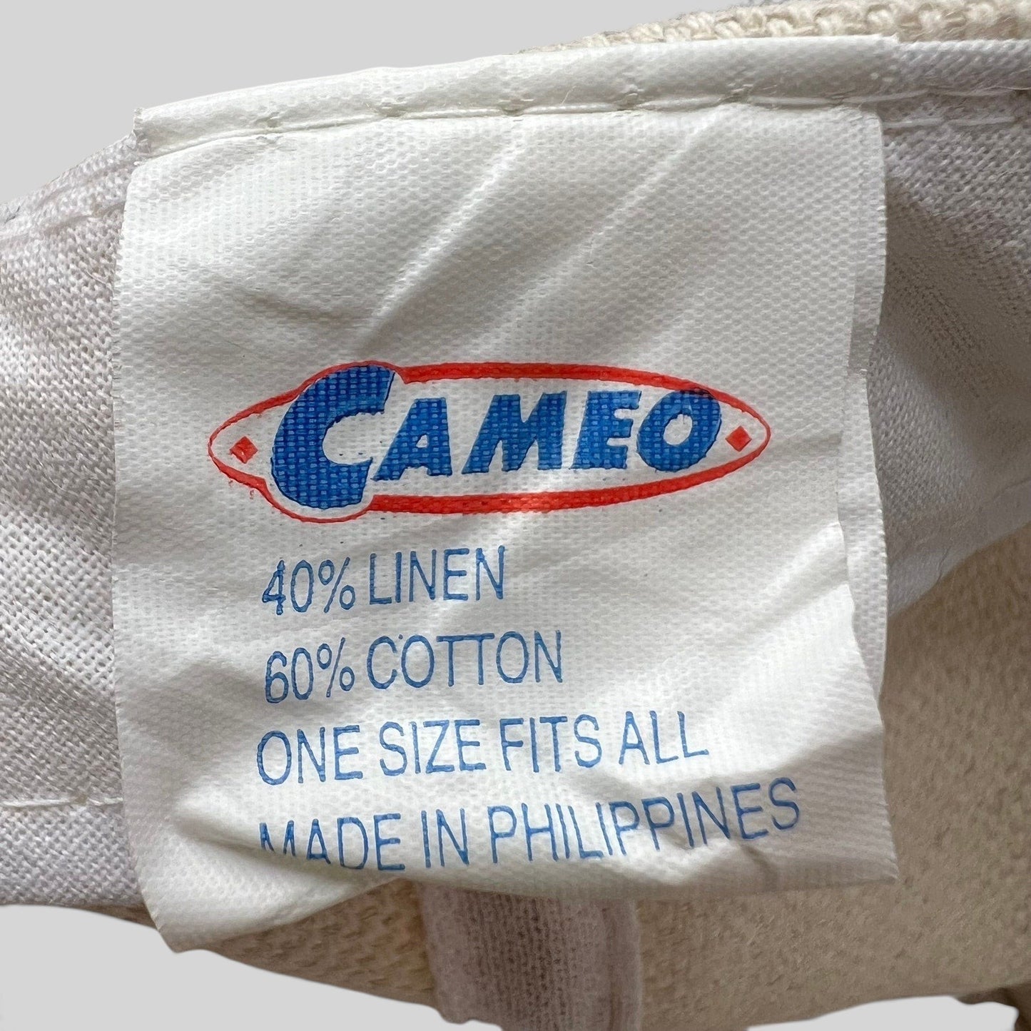 Raree Finds vintage Cameo snapback hat fabric care label showing 40 percent linen and 60 percent cotton composition