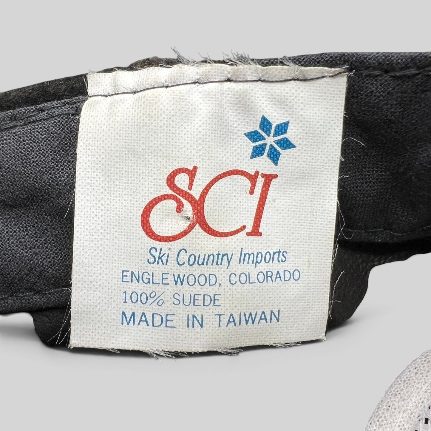 Raree Finds vintage Ski Country Imports clothing label showing 100% suede material and made in Taiwan details