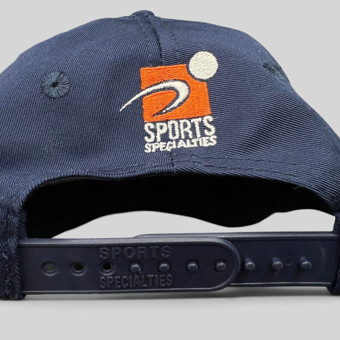 Raree Finds vintage Sports Specialties snapback hat back view showing navy cotton fabric and plastic snap closure