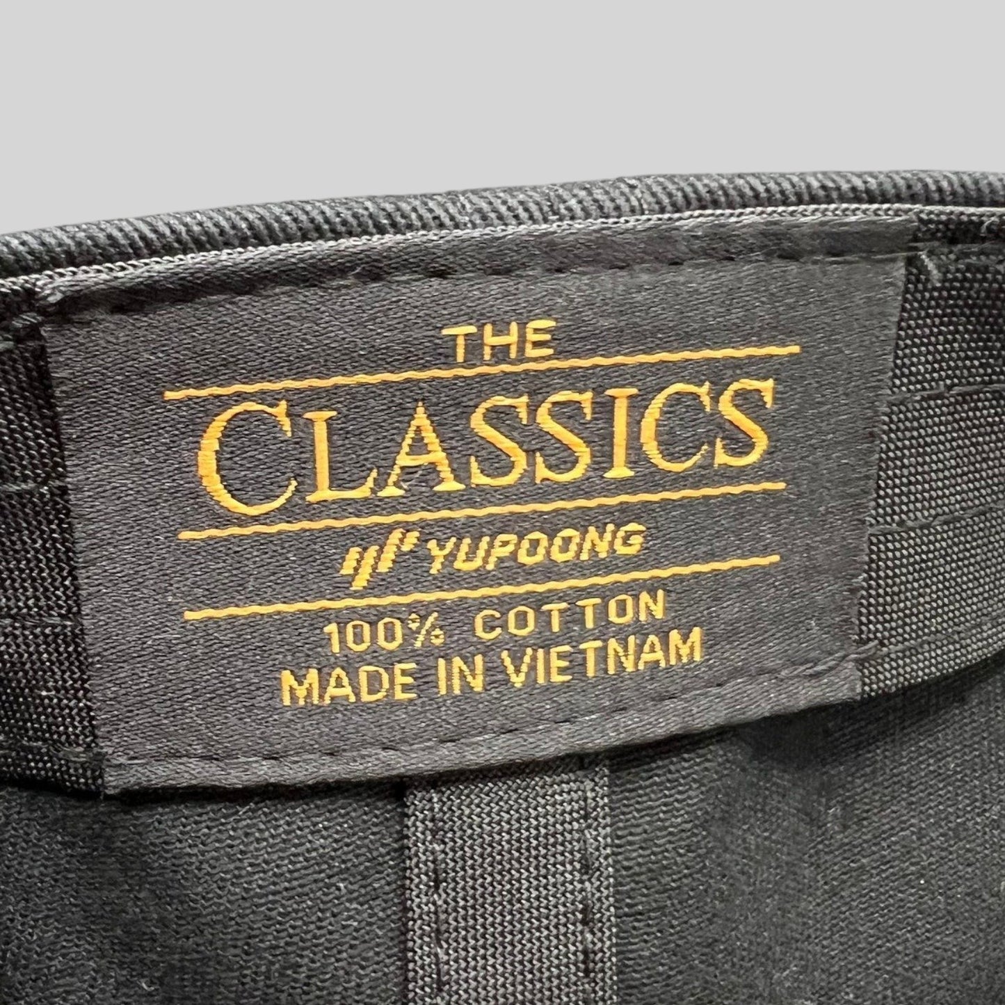 Raree Finds Yupoong The Classics black cotton hat interior label with gold embroidery