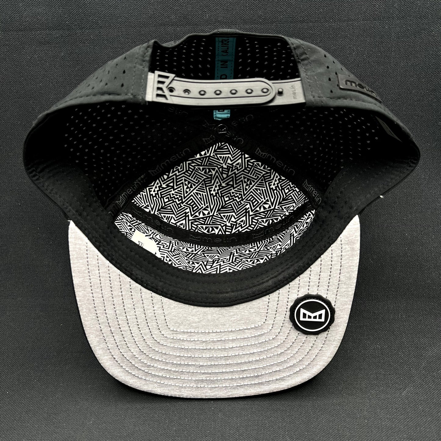 Melin Trenches Hydro Black Snapback Hat Water Resistant Performance Cap