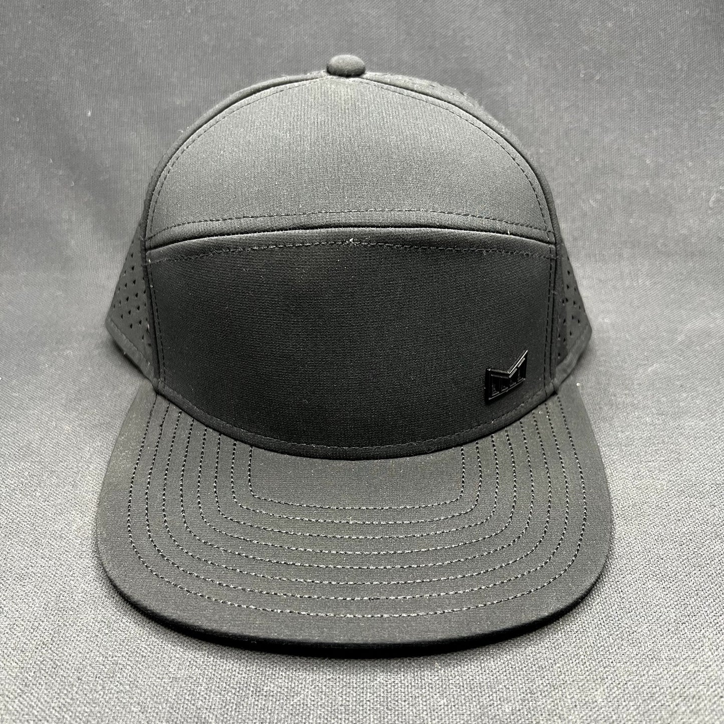Melin Trenches Hydro Black Snapback Hat Water Resistant Performance Cap