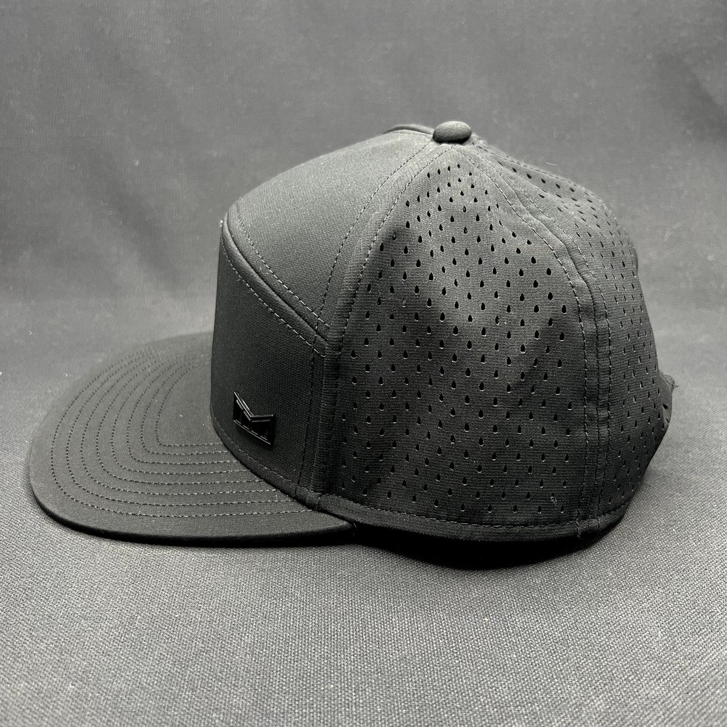 Melin Trenches Hydro Black Snapback Hat Water Resistant Performance Cap