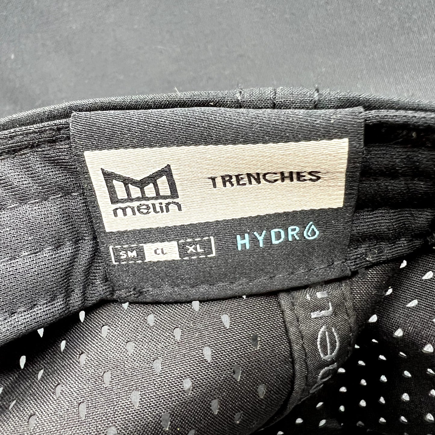 Melin Trenches Hydro Black Snapback Hat Water Resistant Performance Cap