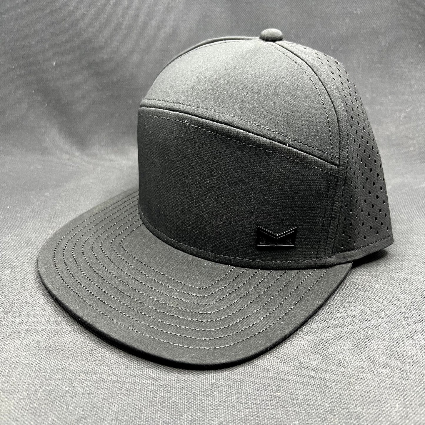Melin Trenches Hydro Black Snapback Hat Water Resistant Performance Cap