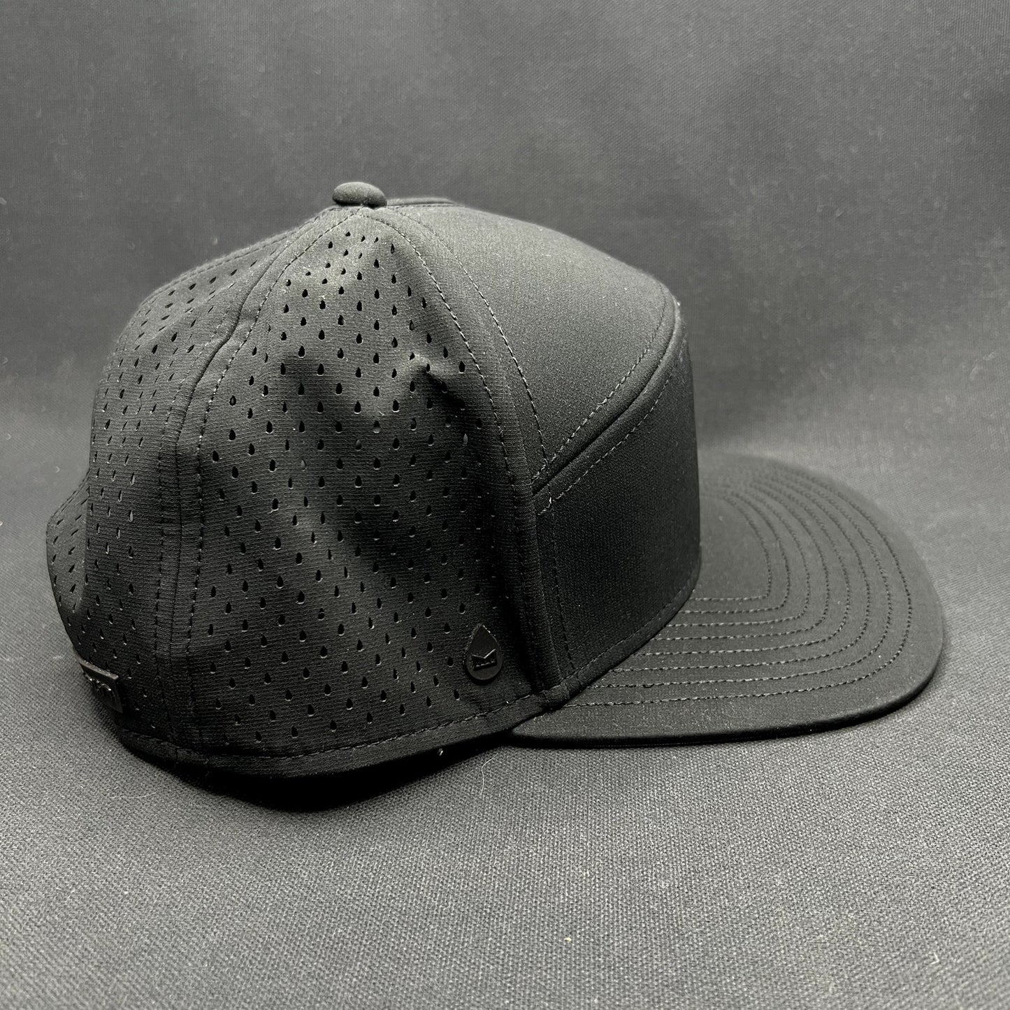 Melin Trenches Hydro Black Snapback Hat Water Resistant Performance Cap