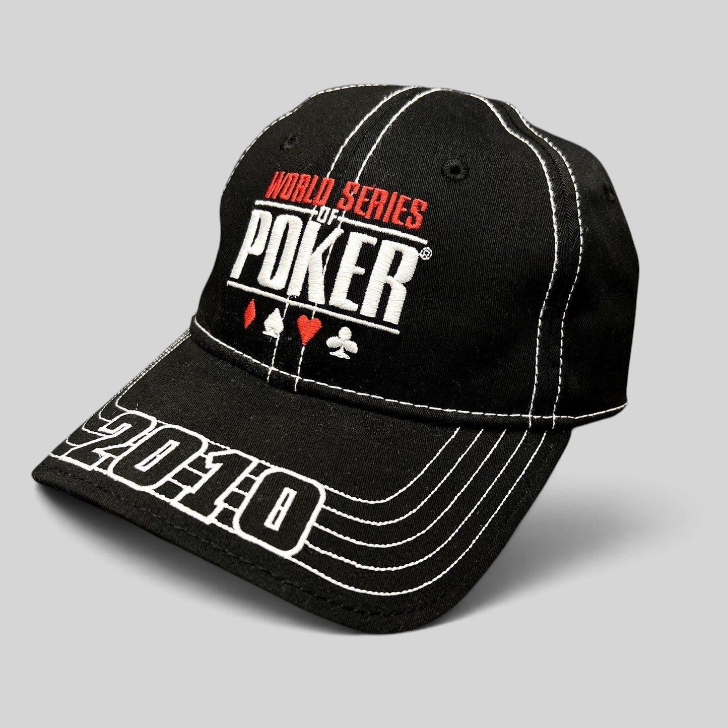 Raree Finds black 2010 World Series of Poker flexfit hat with embroidered logo, card suits, and brim stitching.