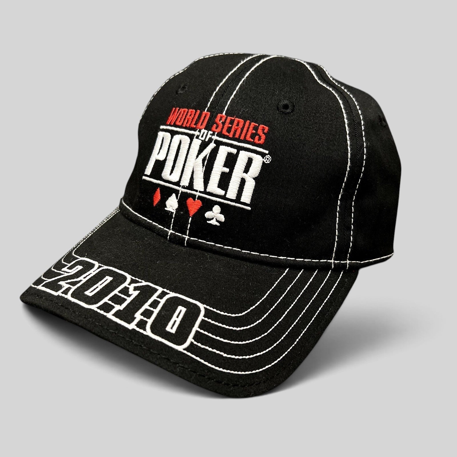 Raree Finds black 2010 World Series of Poker flexfit hat with embroidered logo, card suits, and brim stitching.