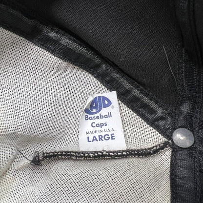 Raree Finds vintage AJD Baseball Caps tag inside a black snapback hat made in the USA