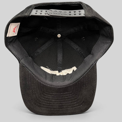 Interior view of a black Raree Finds vintage Mission Impossible 2 corduroy snapback hat showing the adjustable strap.