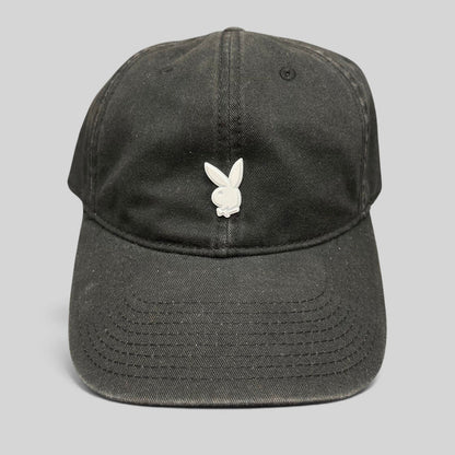 Raree Finds black strapback hat featuring a minimalist silver metal Playboy bunny logo on the front crown.