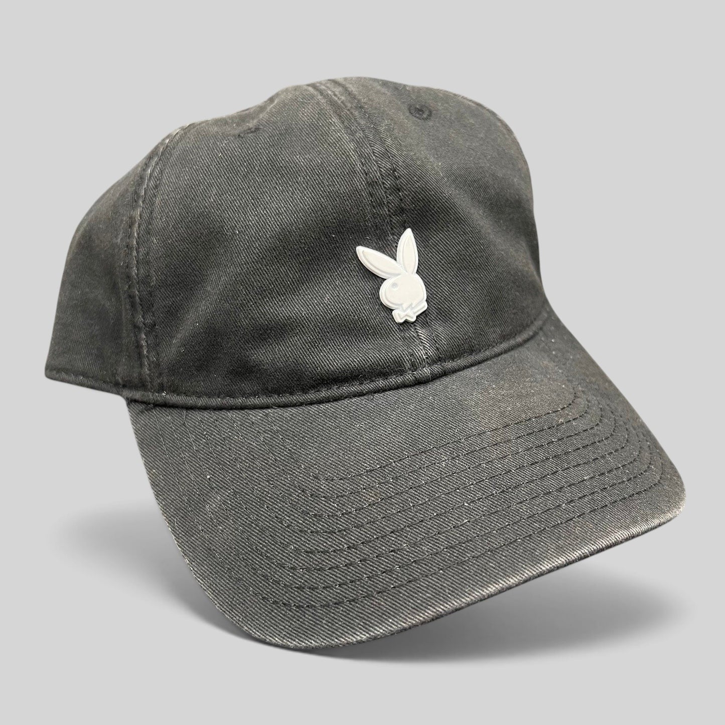 Raree Finds black cotton strapback hat featuring a minimalist silver metal Playboy bunny logo on the front crown