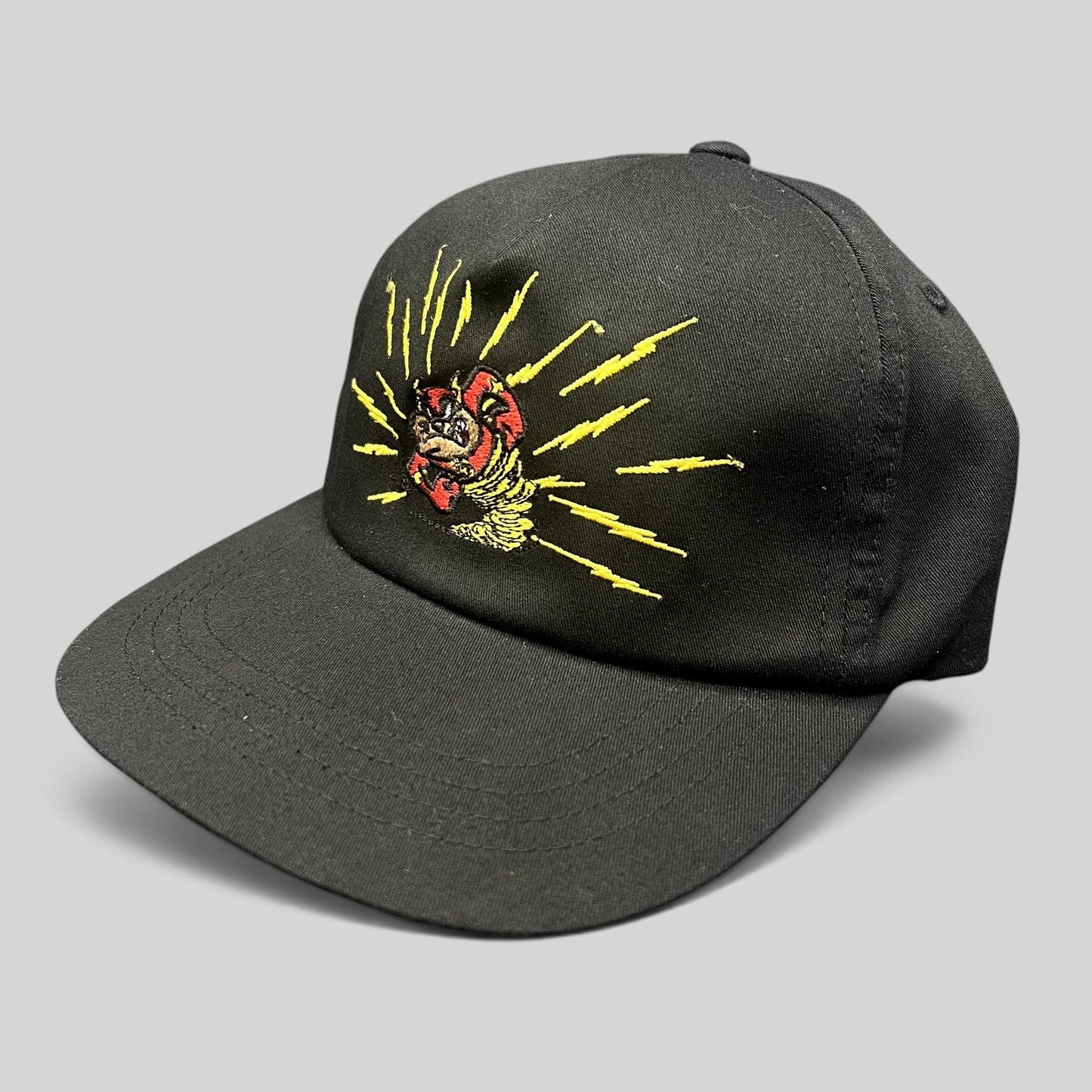 Raree Finds black snapback hat featuring an embroidered Tasmanian Devil graphic with yellow lightning bolt details.