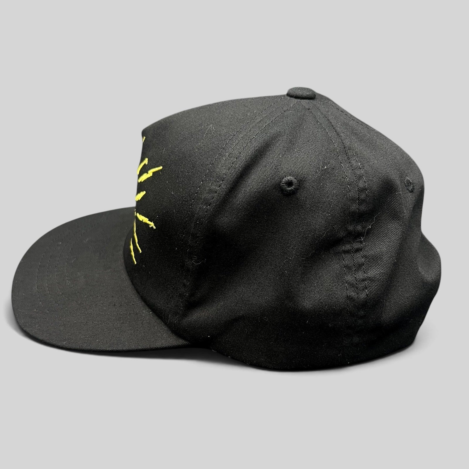 Raree Finds black The Hundreds x Looney Tunes snapback hat with yellow embroidered Tasmanian Devil lightning detail