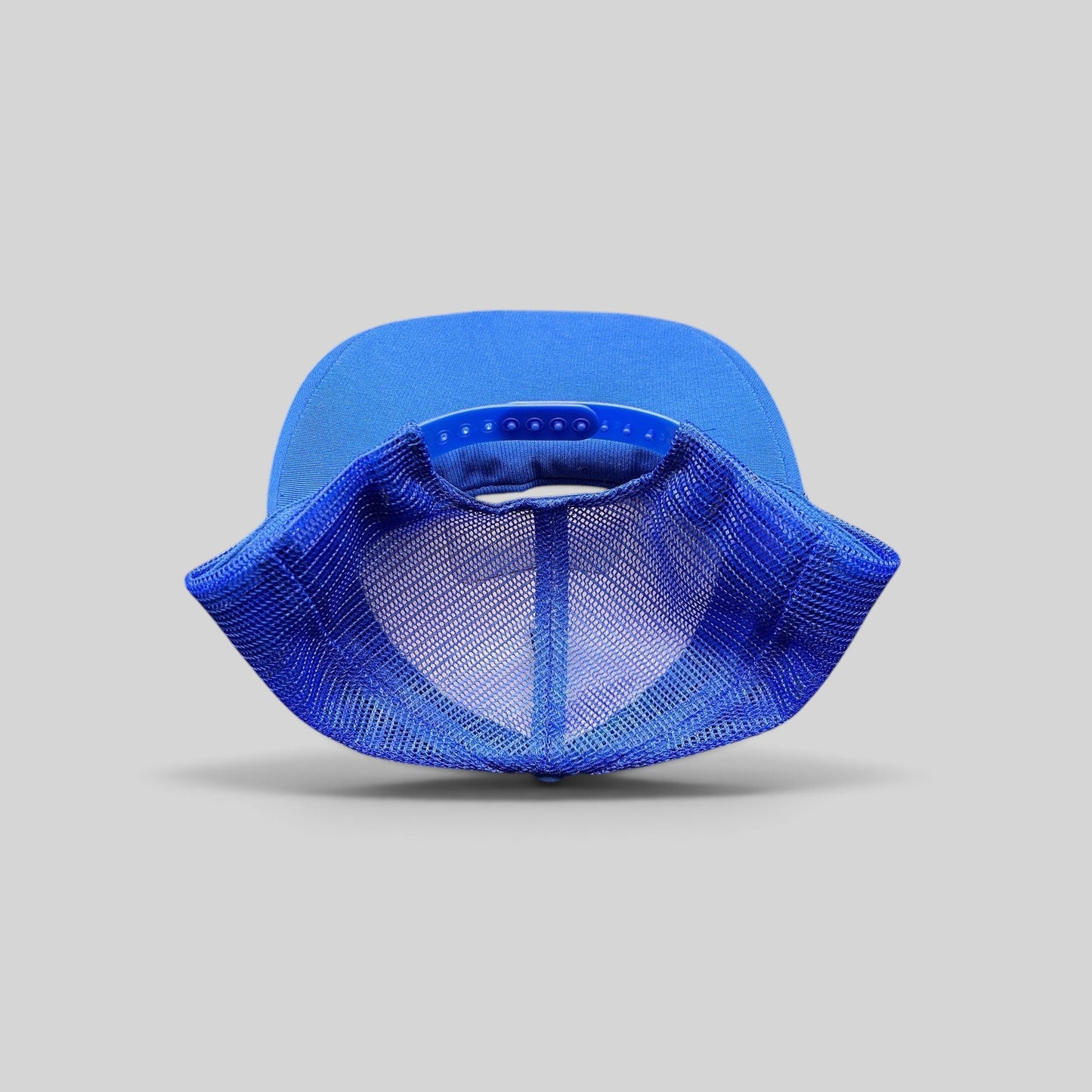 Raree Finds vintage 1980s royal blue trucker hat showing the adjustable snapback closure and breathable mesh back