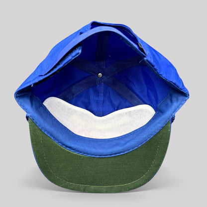 Raree Finds vintage blue nylon strapback hat with green underbrim, showing the interior construction and lining.