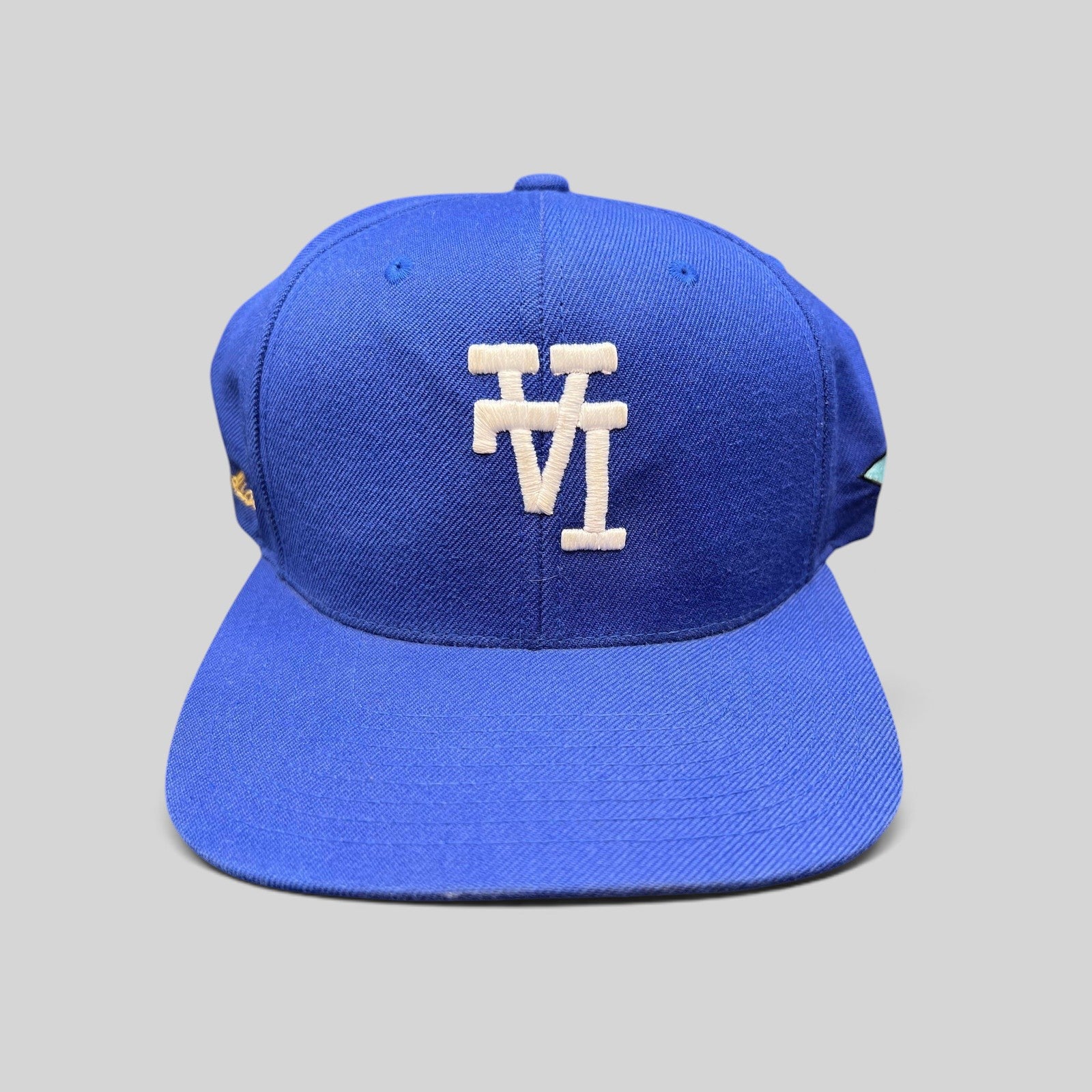 Raree Finds royal blue Uniform Studios Los Angeles snapback hat with white embroidered logo and green undervisor