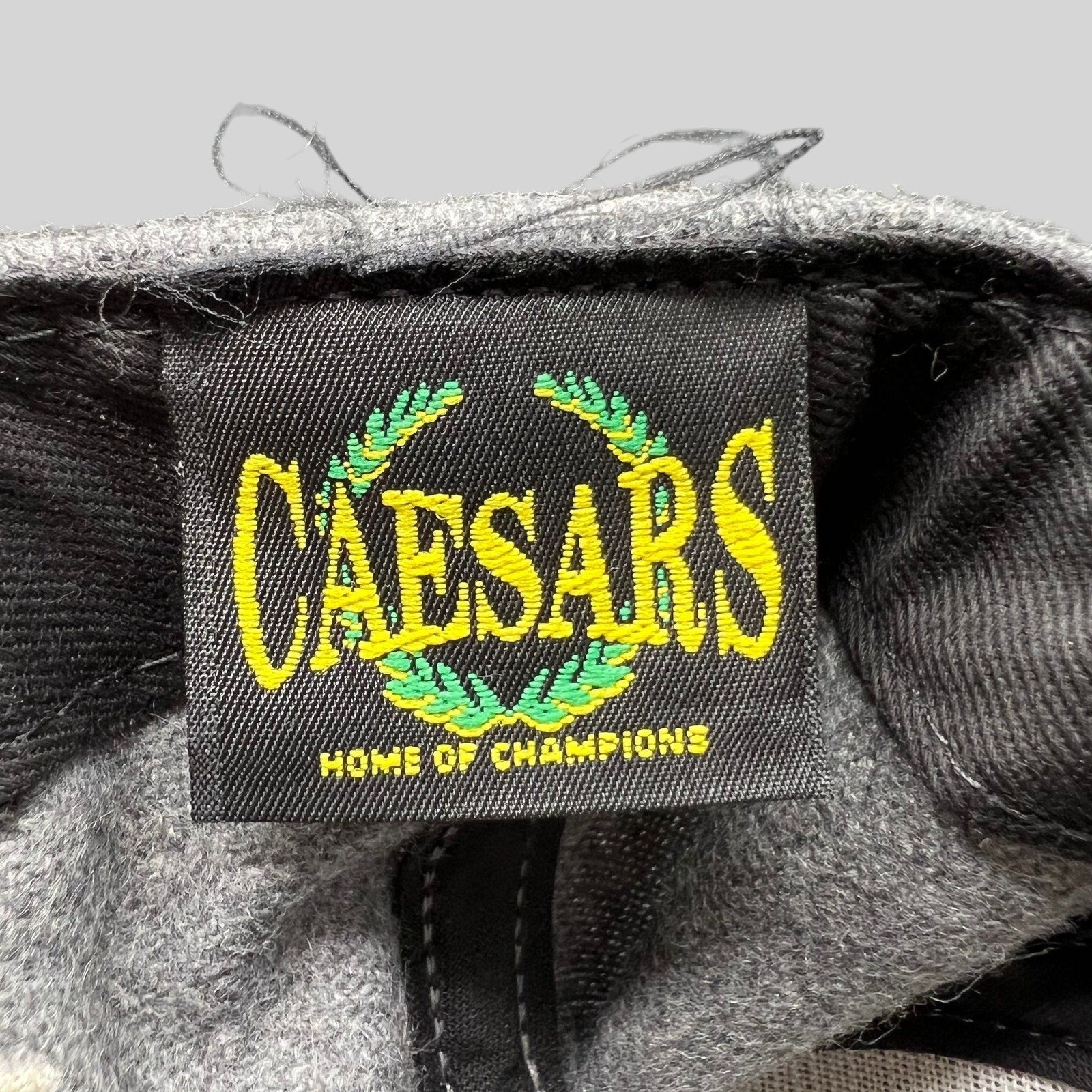 Raree Finds vintage Caesars Home of Champions embroidered brand label inside a grey wool-blend snapback hat