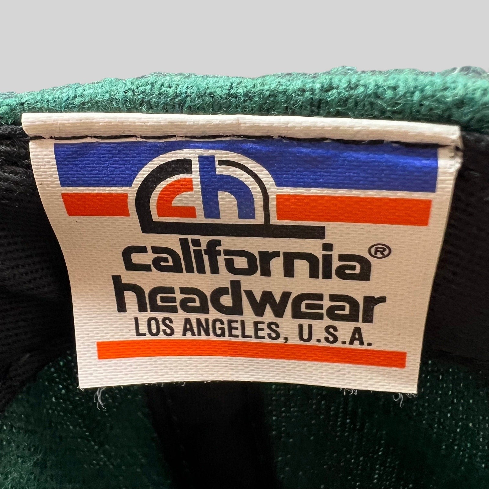 Raree Finds vintage California Headwear label inside a green wool-blend snapback hat