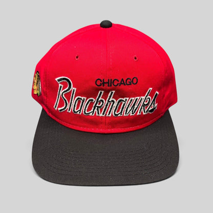 Raree Finds vintage 90s Chicago Blackhawks snapback hat with red crown, black brim, and silver script embroidery.