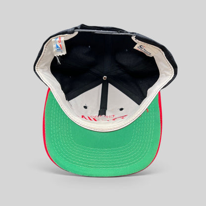 Raree Finds vintage 90s Chicago Bulls snapback hat showing the interior green undervisor and original brand tags.