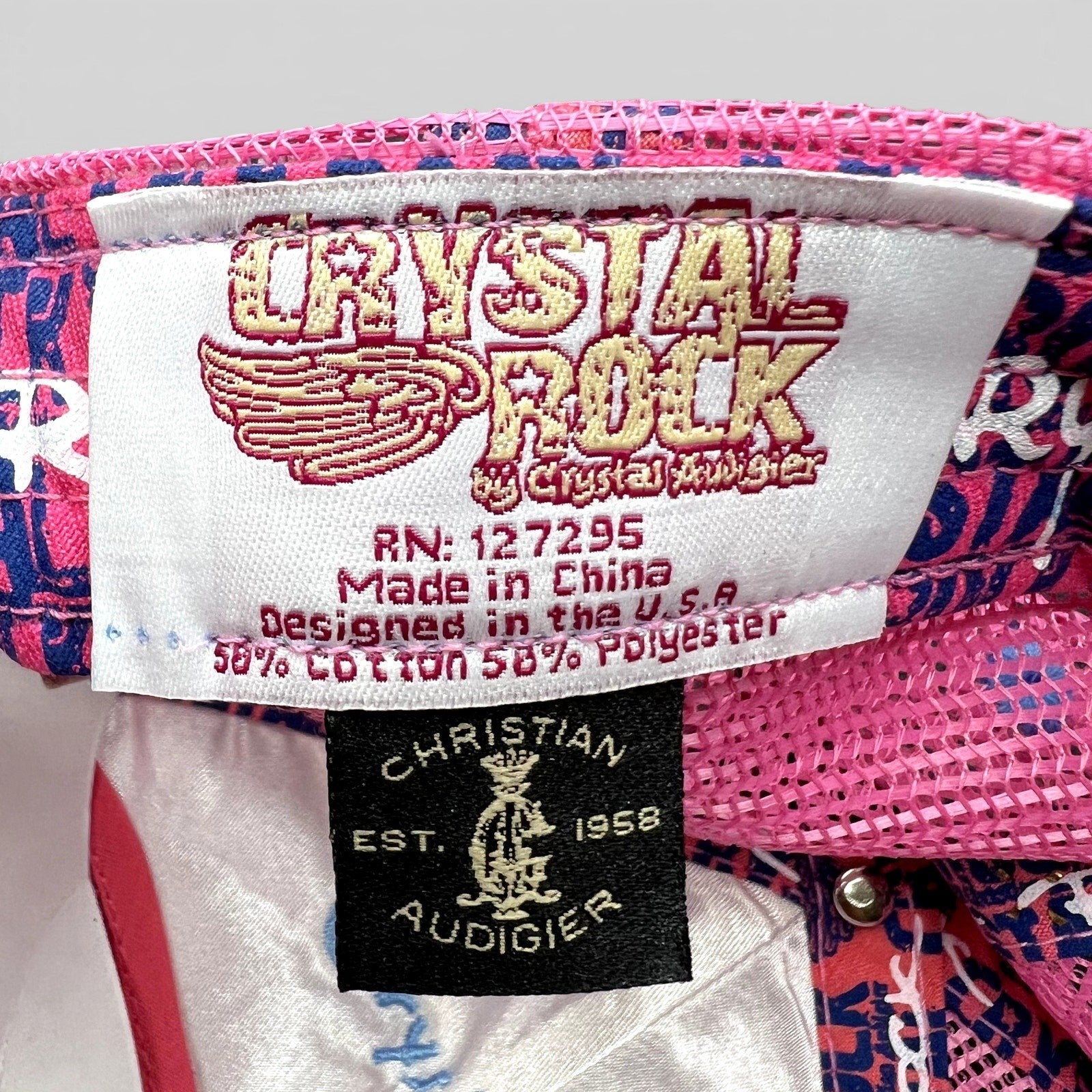 Raree Finds Crystal Rock by Christian Audigier trucker hat inner brand and material label with pink mesh background