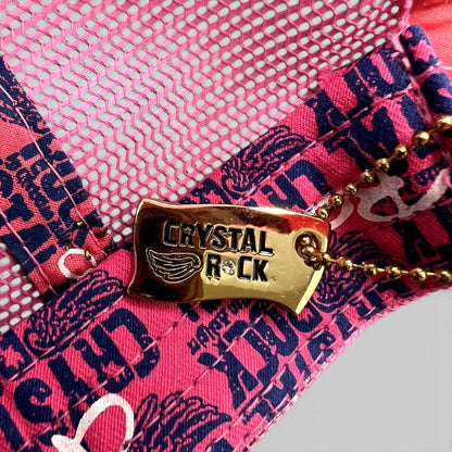 Raree Finds Crystal Rock by Christian Audigier pink trucker hat featuring a gold branded metal tag with rhinestones