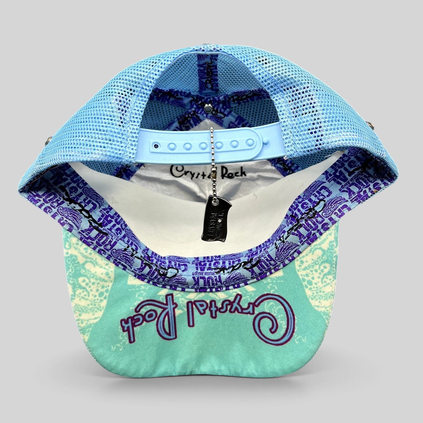 Raree Finds Crystal Rock by Christian Audigier teal mesh trucker hat with branded interior tape and metal tag