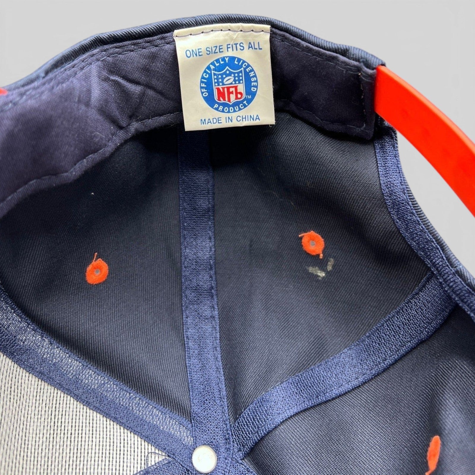 Raree Finds vintage Denver Broncos snapback interior showing NFL officially licensed tag and orange snap closure