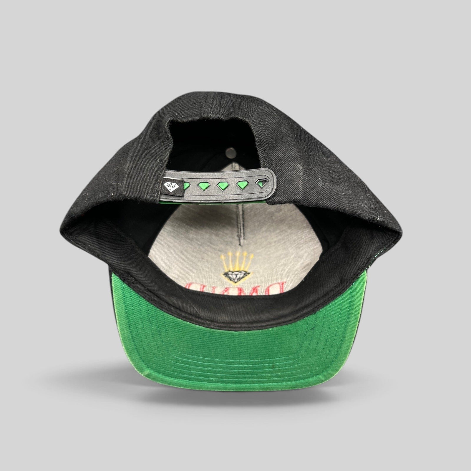 Raree Finds vintage Diamond Supply Co. black snapback hat with green underbrim and crown logo snapback closure