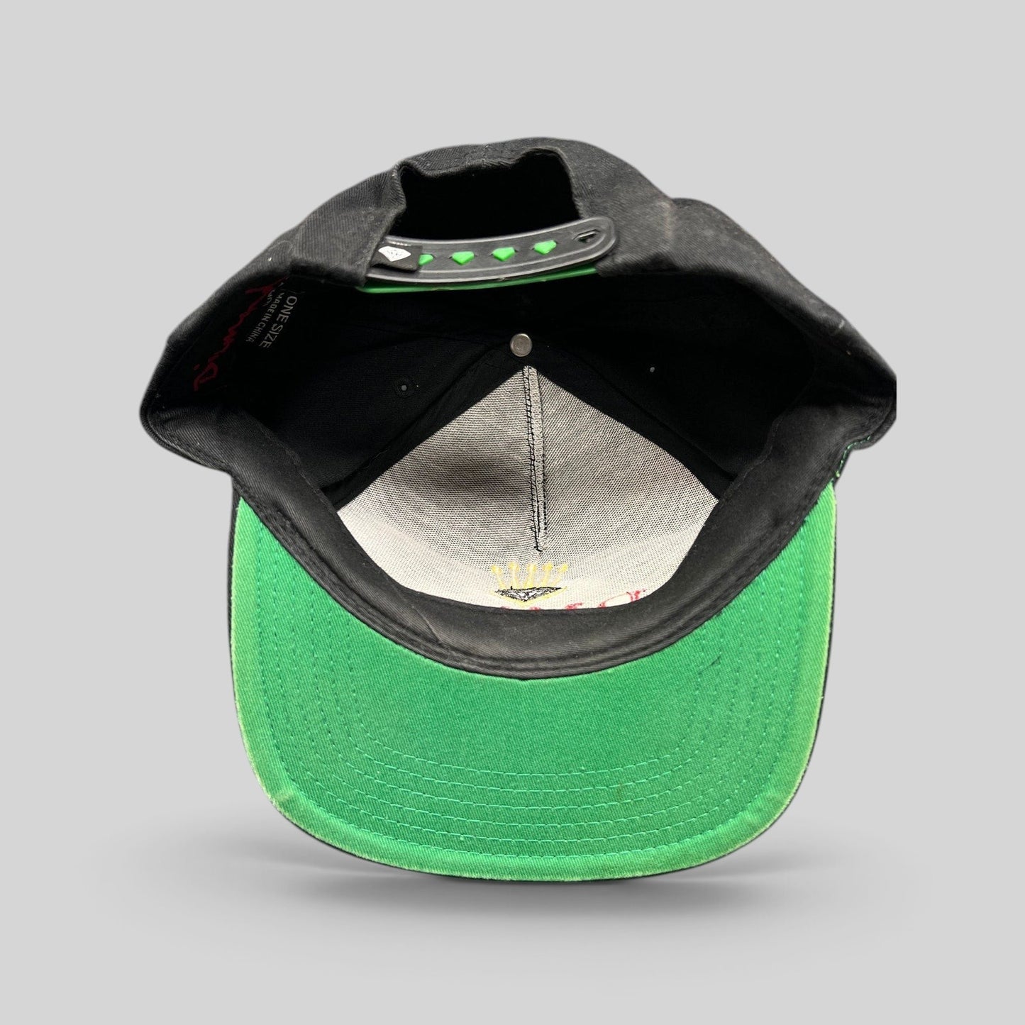 Raree Finds vintage Diamond Supply Co. black snapback hat with green underbrim and interior crown logo embroidery