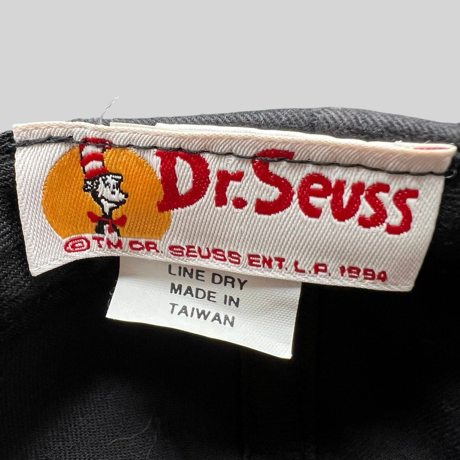 Raree Finds vintage 1994 Dr. Seuss Cat in the Hat snapback hat interior tag showing brand and origin details