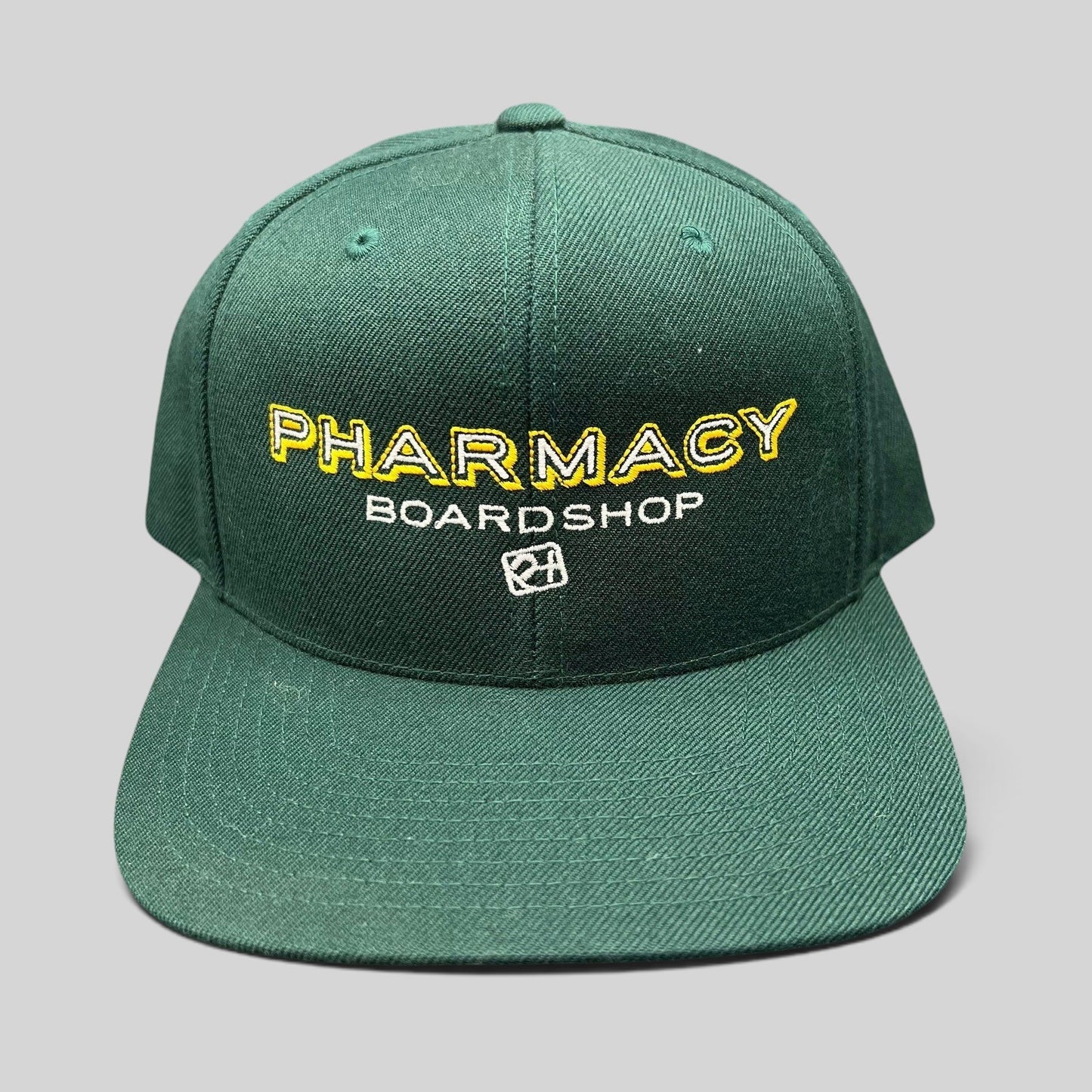 Raree Finds vintage forest green Pharmacy Boardshop snapback hat with yellow and white embroidered skate branding