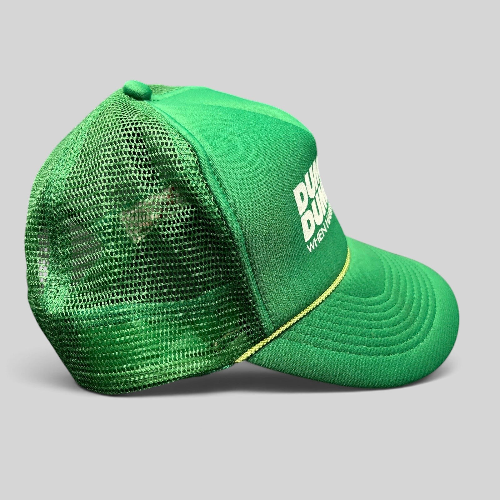 Raree Finds green Dumb and Dumberer promotional trucker hat with white graphic, foam front, and mesh back.