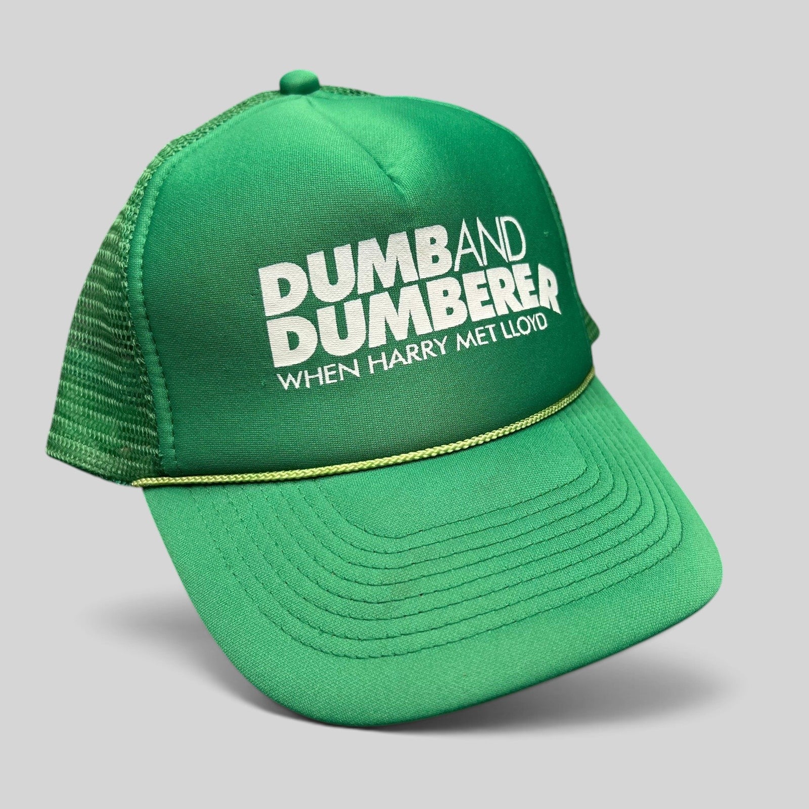 Raree Finds vintage green foam trucker hat with white Dumb and Dumberer movie promo print and rope brim detail