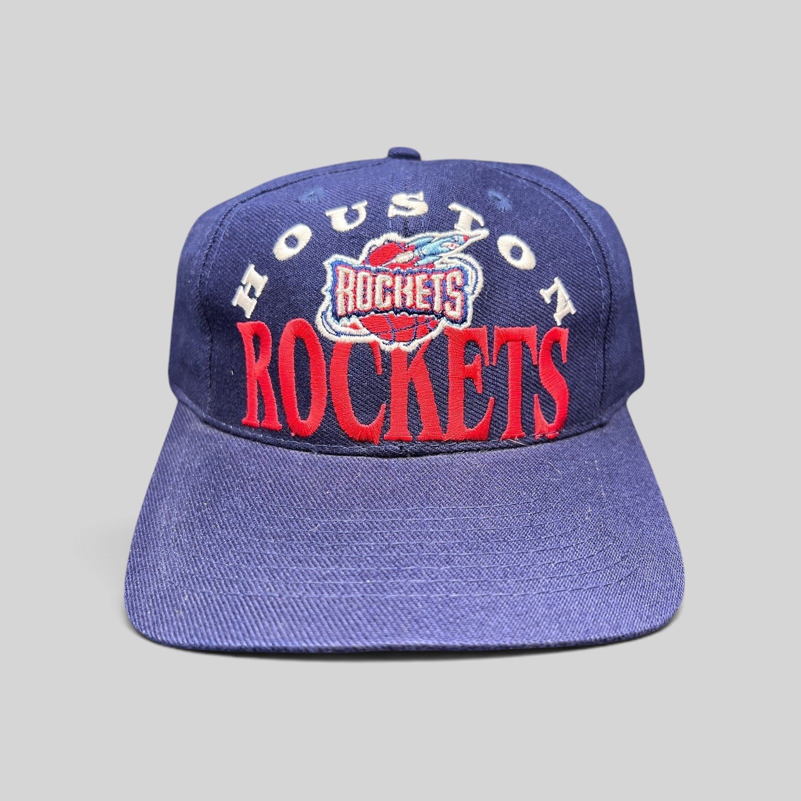 Raree Finds vintage 1990s Houston Rockets snapback hat in navy blue with red embroidered logo and green undervisor