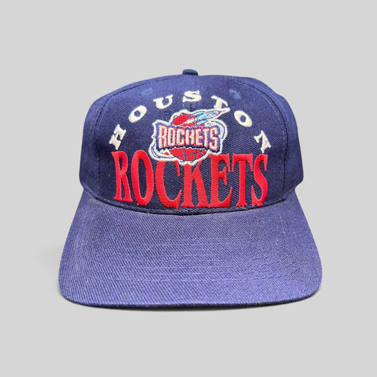Raree Finds vintage 1990s Houston Rockets snapback hat in navy blue with red embroidered logo and green undervisor