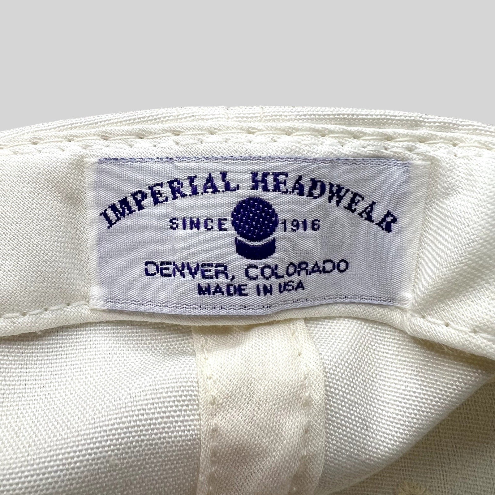 Raree Finds vintage Imperial Headwear label showing Denver Colorado and Made in USA text on a white golf hat
