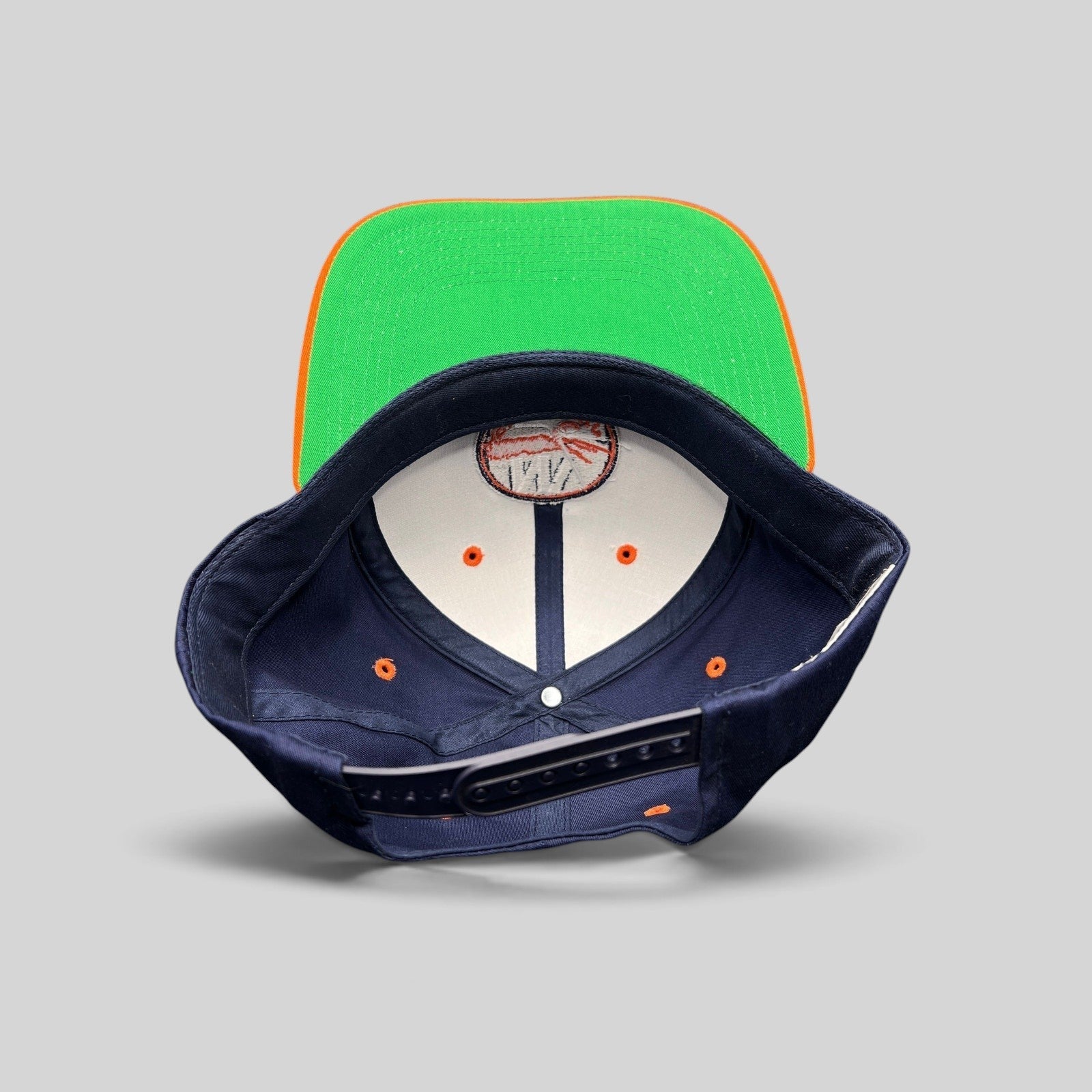 Raree Finds vintage New York Islanders snapback hat with navy crown, orange brim, and classic green undervisor.