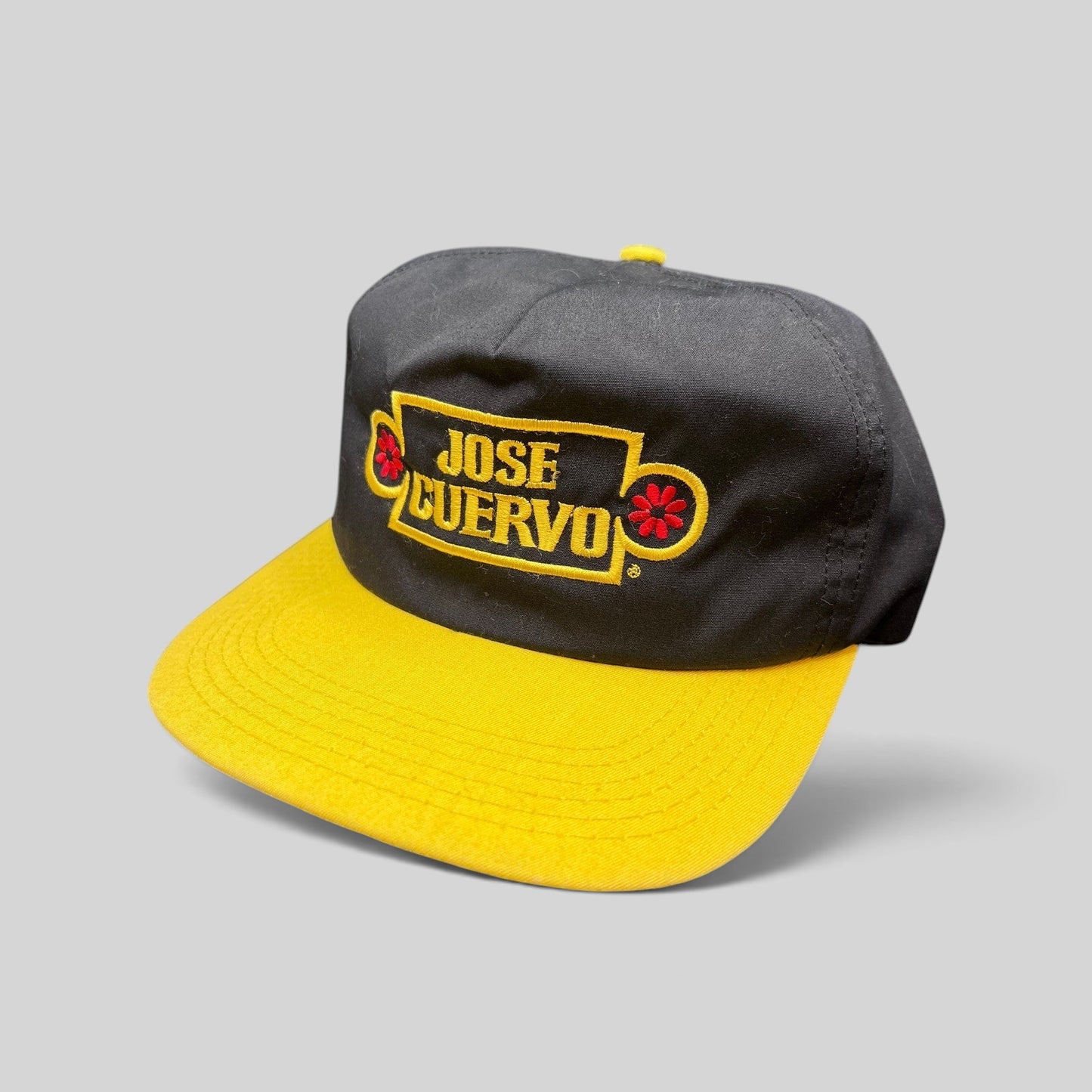 Raree Finds vintage Jose Cuervo snapback hat with black crown, gold brim, and embroidered logo in gold and red.