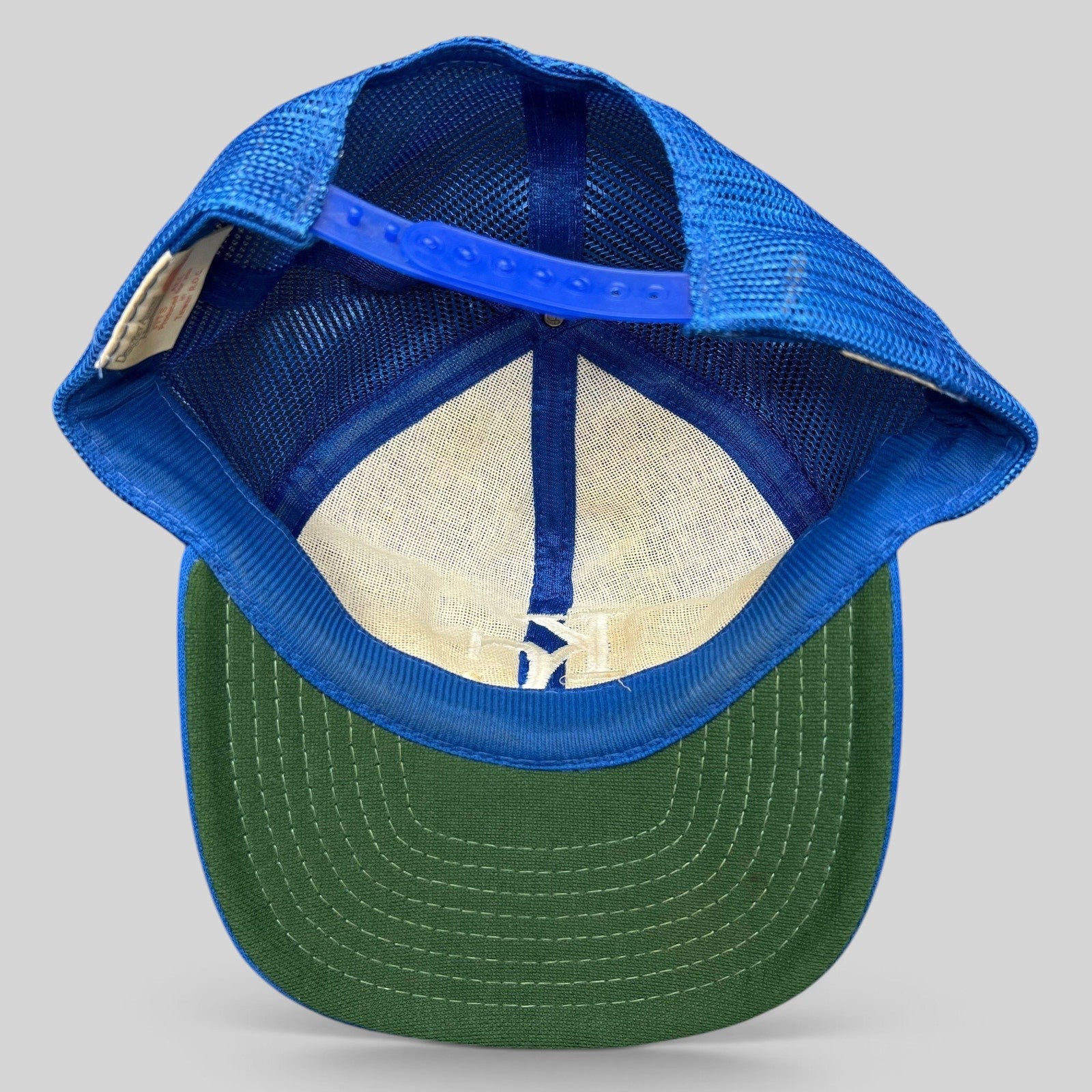 Raree Finds vintage Kansas City Royals trucker hat interior view showing green undervisor and blue mesh back