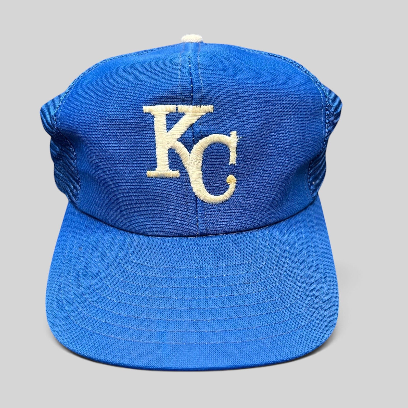 Raree Finds vintage Kansas City Royals trucker hat with royal blue foam front, off-white KC logo, and mesh back.