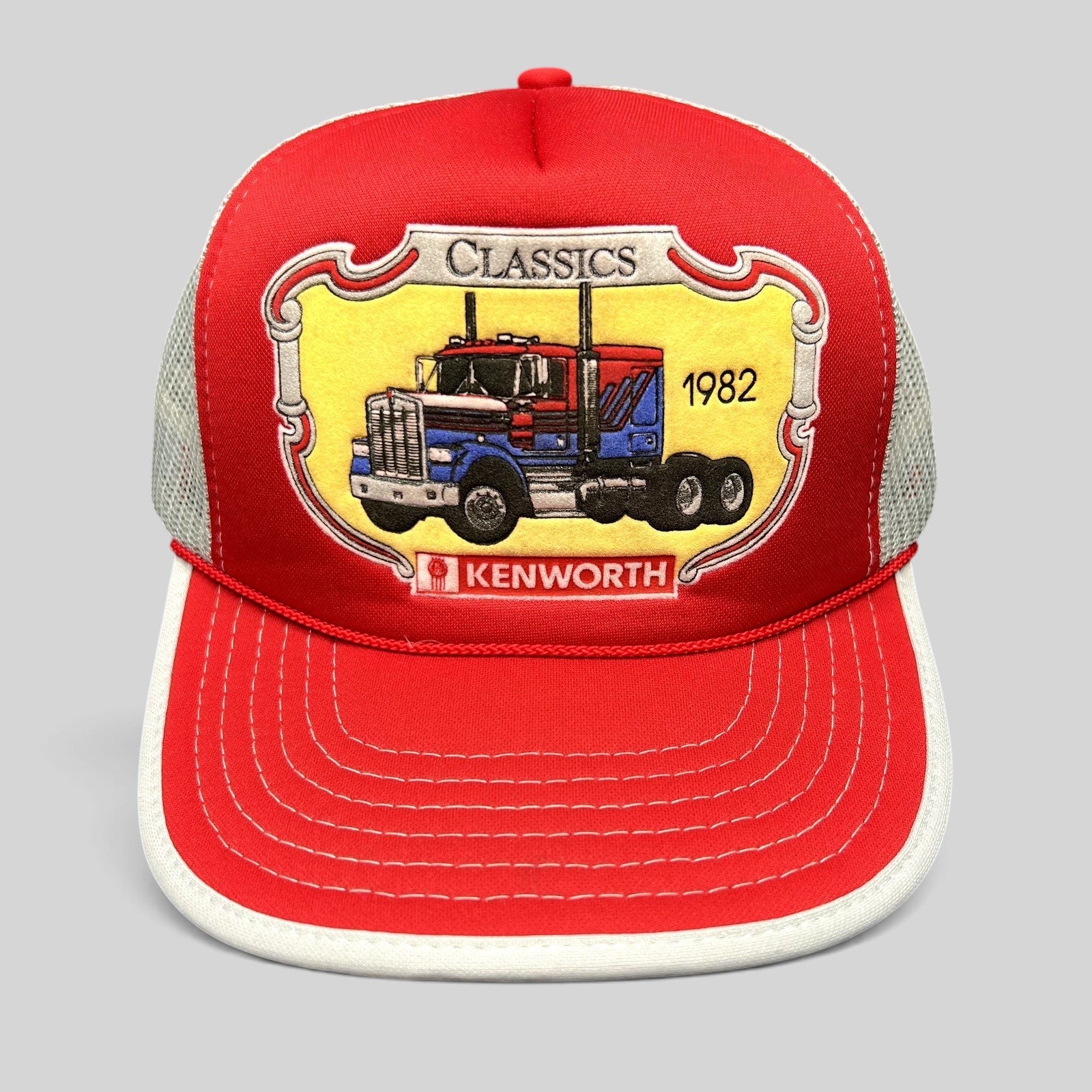 Raree Finds vintage 90s Kenworth Trucks trucker hat with red foam front, white mesh back, and 1982 semi-truck graphic.