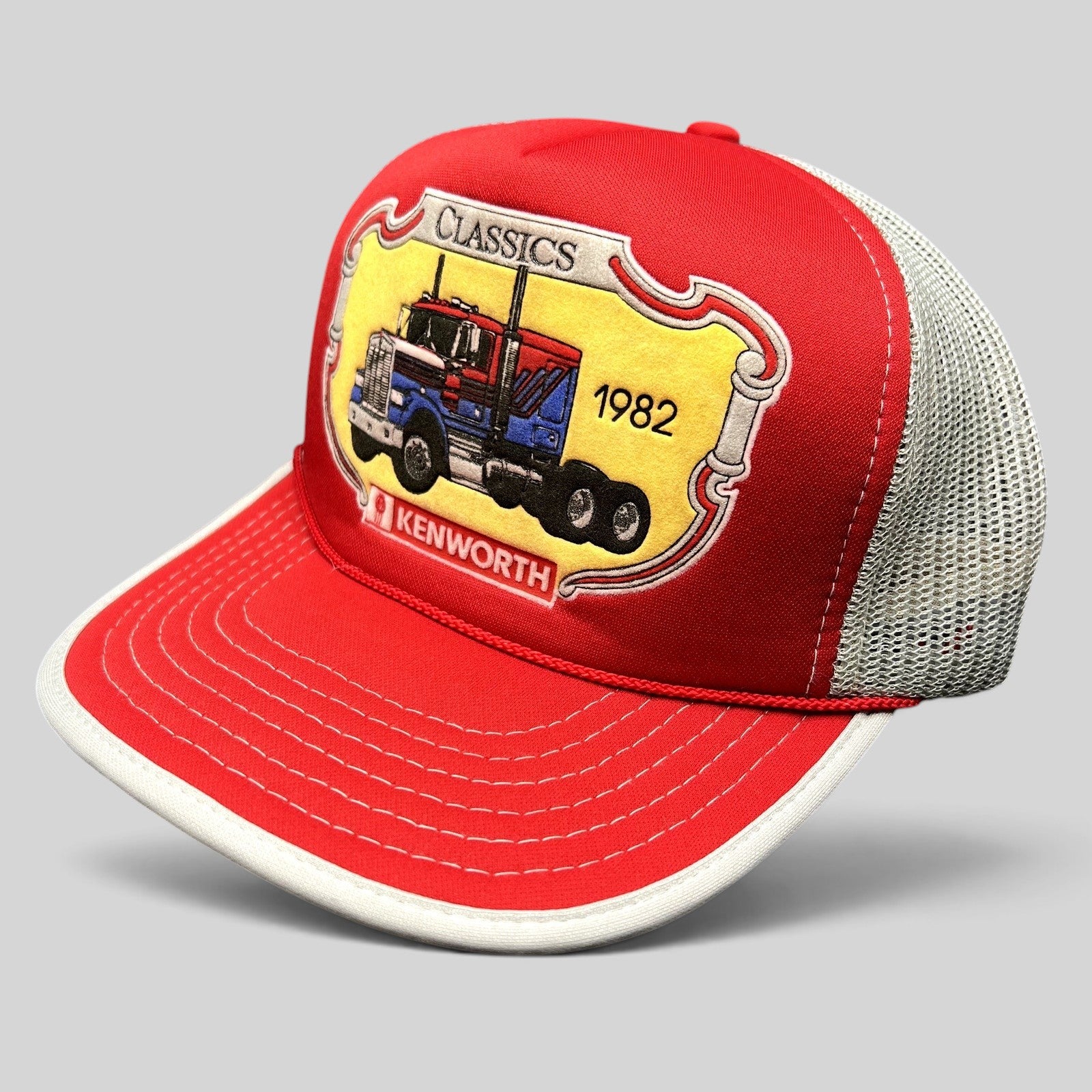 Raree Finds vintage 90s Kenworth Trucks trucker hat with red foam front, white mesh back, and 1982 semi-truck graphic.