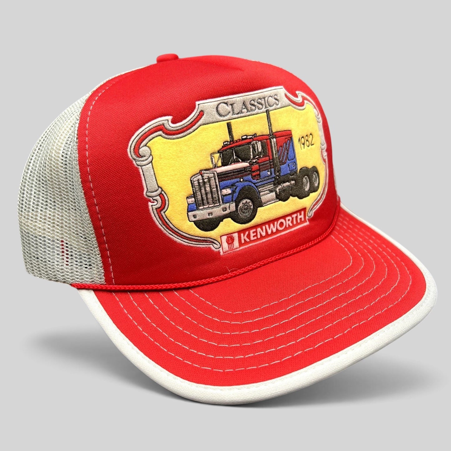 Raree Finds vintage 90s Kenworth Trucks trucker hat with red foam front, white mesh back, and 1982 semi-truck graphic.