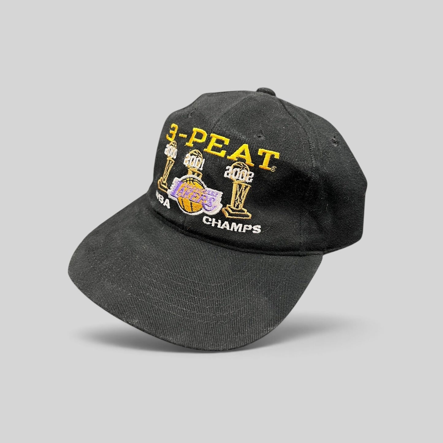 Raree Finds vintage black cotton Los Angeles Lakers 3-Peat NBA championship hat with gold and purple embroidery.