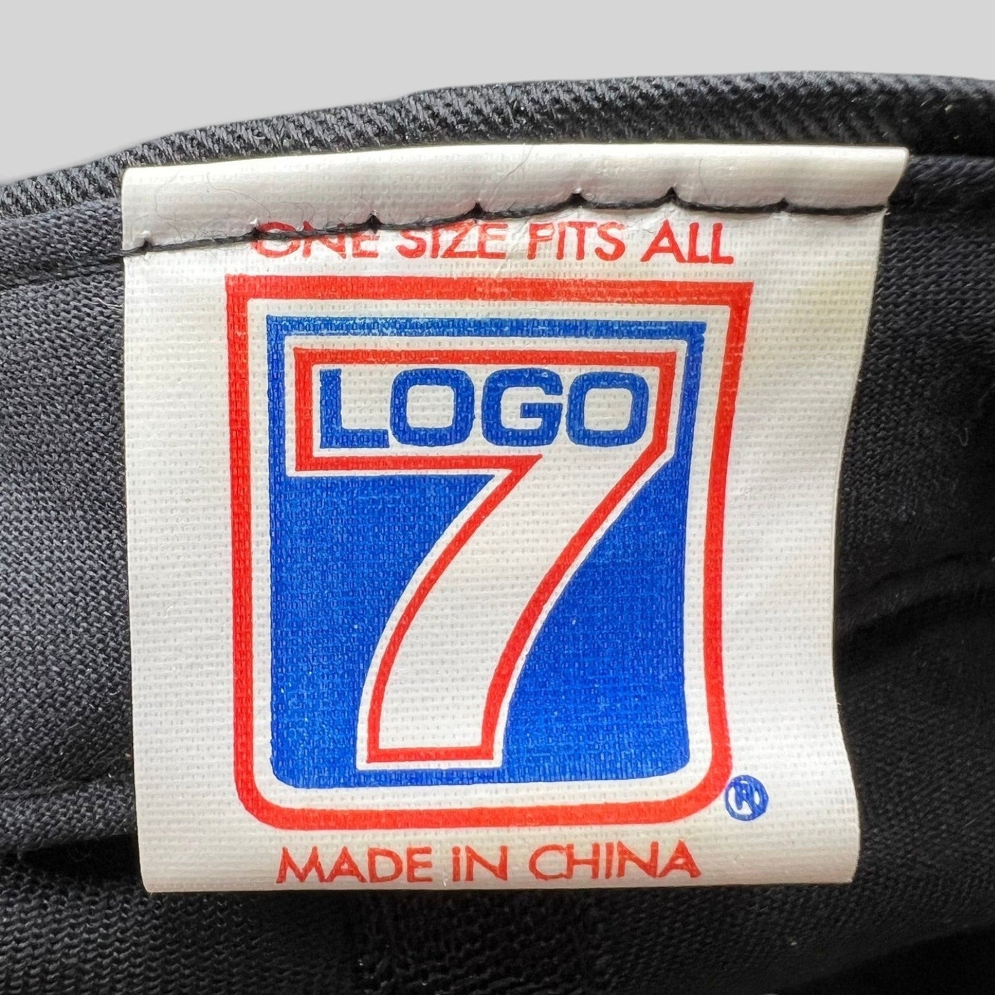 Raree Finds vintage Logo 7 clothing tag with blue and red branding on a white label stitched inside a snapback hat
