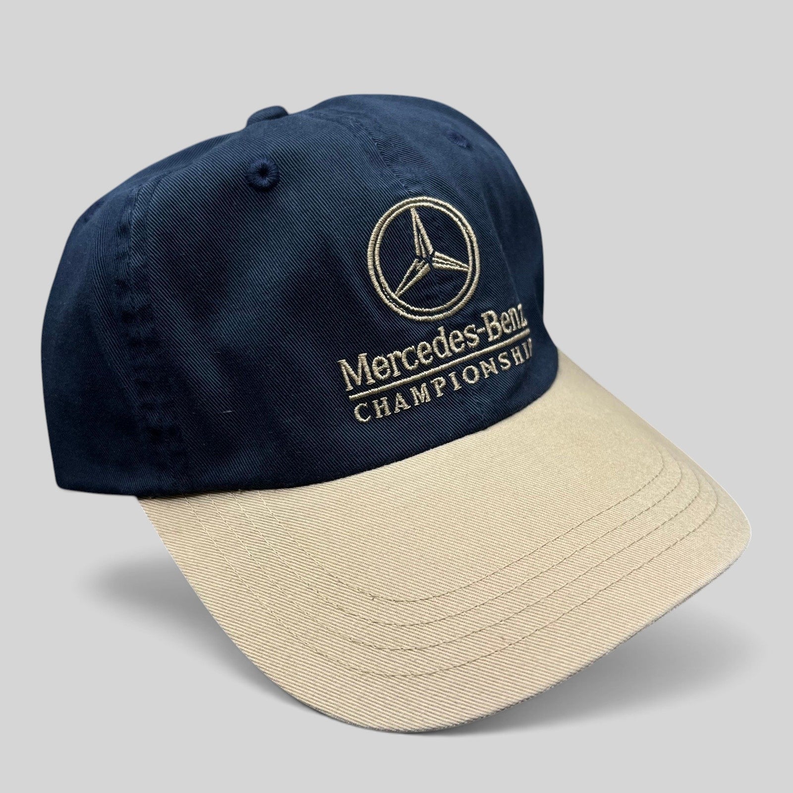 Raree Finds vintage navy and tan cotton strapback golf hat with embroidered Mercedes-Benz Championship logo