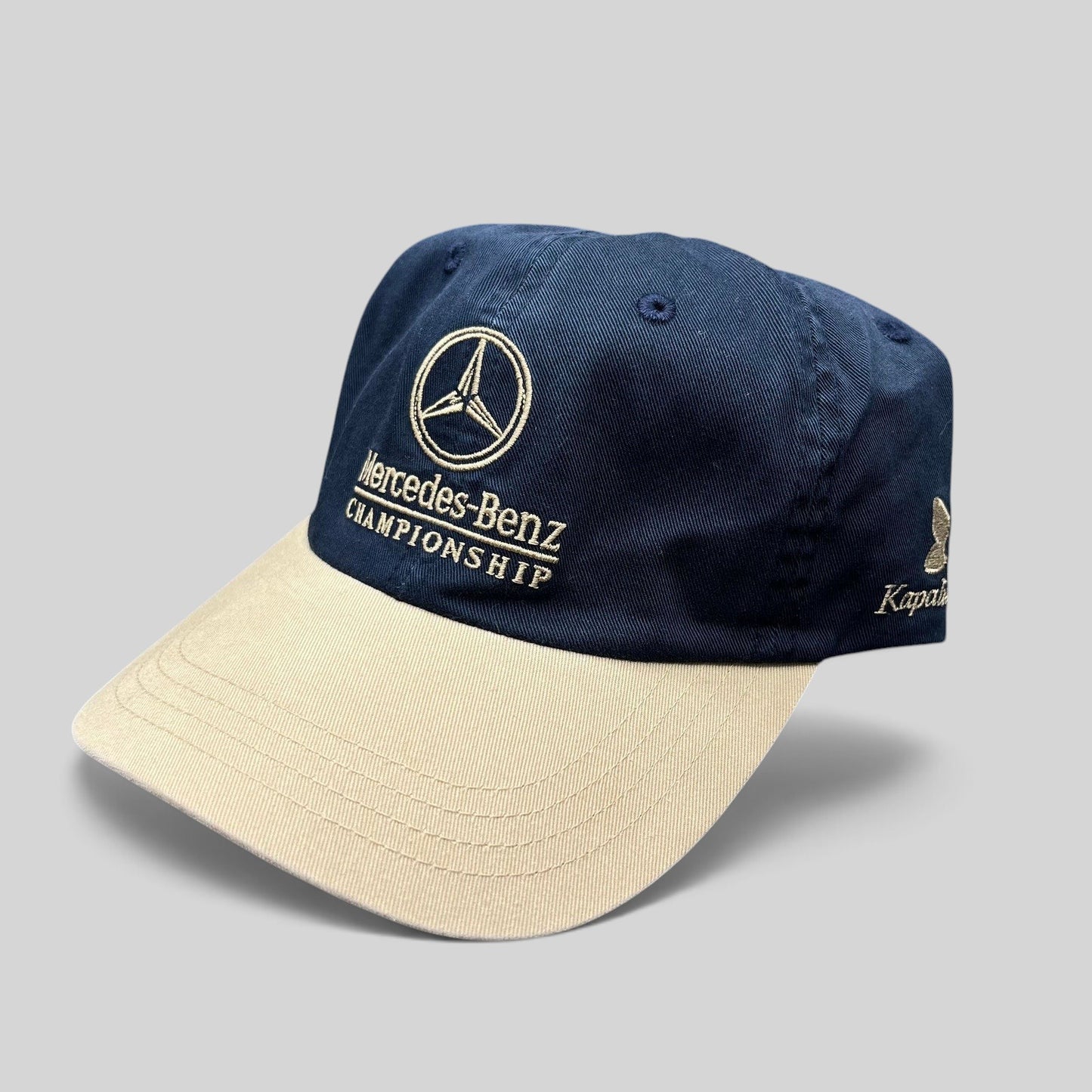 Raree Finds vintage Mercedes-Benz Championship golf hat with a navy cotton crown, tan brim, and embroidered logo.